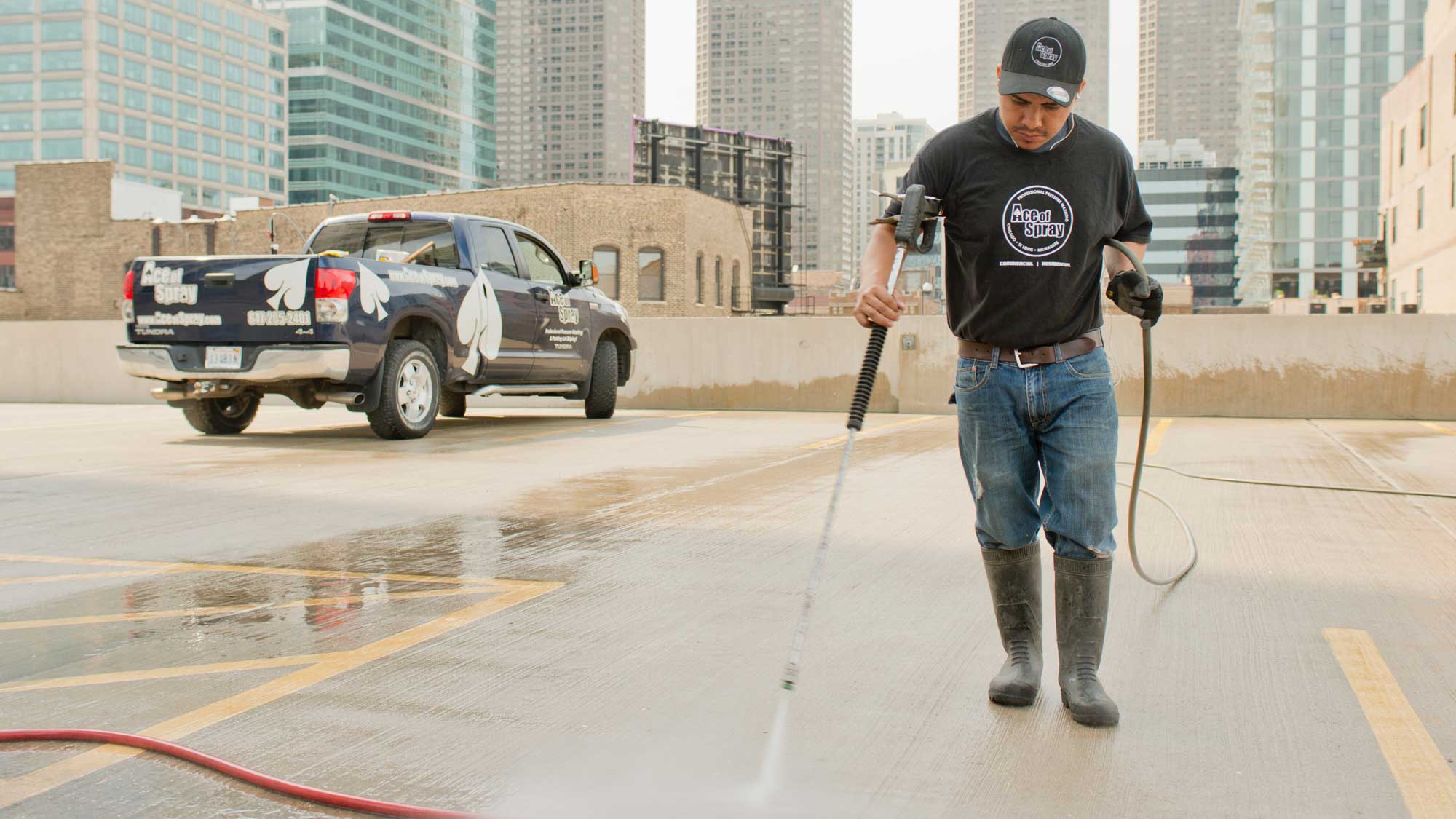 Ace of Spray technician pressure washing in Chicago