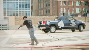 man power washing a parking garage deck in Chicago